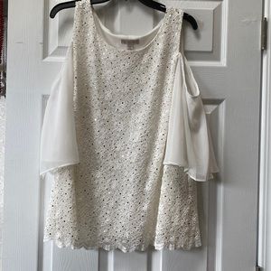 Cream colored blouse with bare shoulders and gold accents
